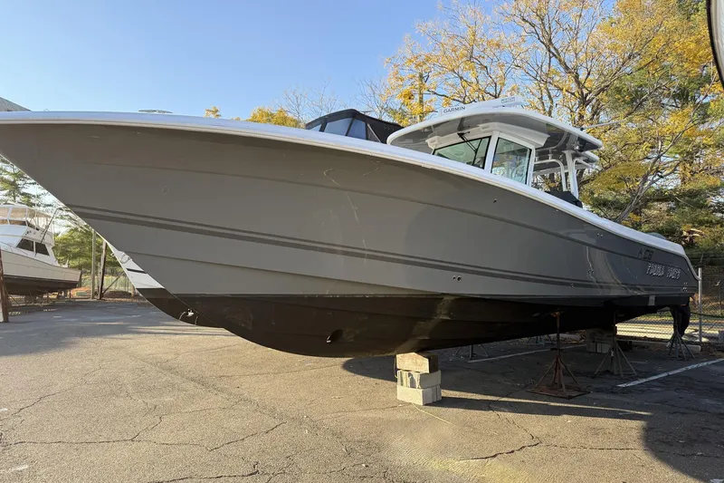 The Image of 2019 HCB 39 Speciale boat on dry dock, surrounded by autumn trees. - 0