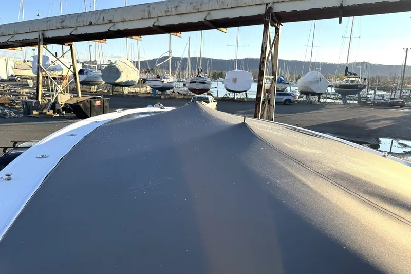 Slide: The Image of 2019 HCB 39 Speciale boat covered in a marina with other boats in the background. - 11
