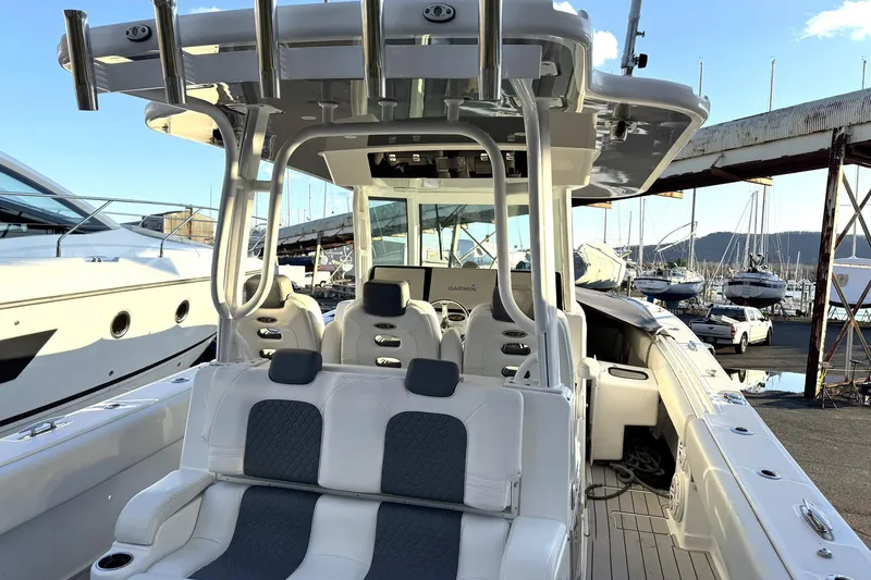 Slide: The Image of 2019 HCB 39 Speciale boat interior with seating and navigation equipment at a marina. - 21