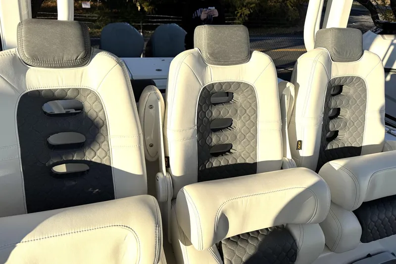 Slide: The Image of Luxurious seating in 2019 HCB 39 Speciale boat, featuring elegant white and gray upholstery. - 25