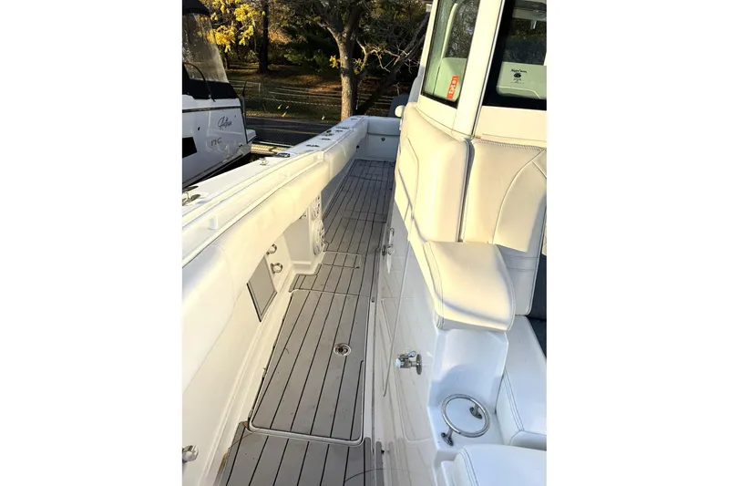Slide: The Image of 2019 HCB 39 Speciale boat interior with sleek white seating and wood-style flooring. - 30