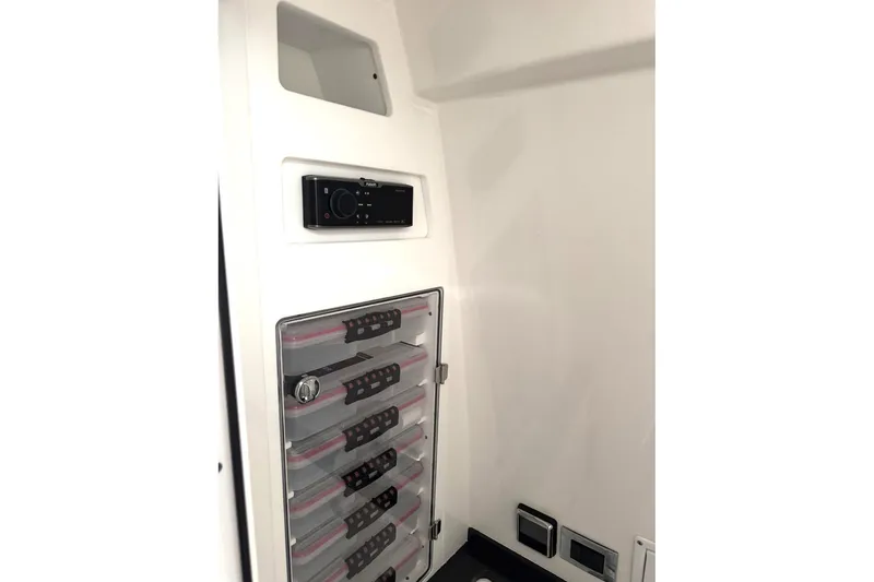 Slide: The Image of 2019 HCB 39 Speciale interior storage with organized compartments and control panel. - 32