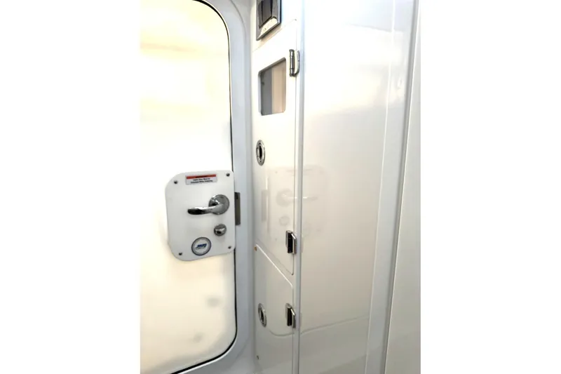 Slide: The Image of Interior cabin door of 2019 HCB 39 Speciale boat, featuring sleek white design. - 33