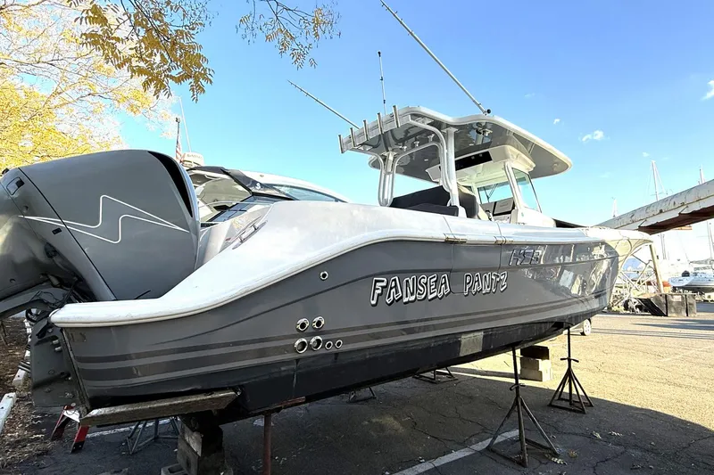 Slide: The Image of 2019 HCB 39 Speciale boat on dry dock, featuring dual outboard engines. - 41