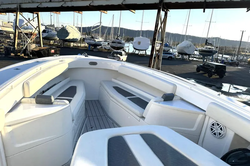 Slide: The Image of 2019 HCB 39 Speciale boat interior with seating, docked at marina with yachts. - 8
