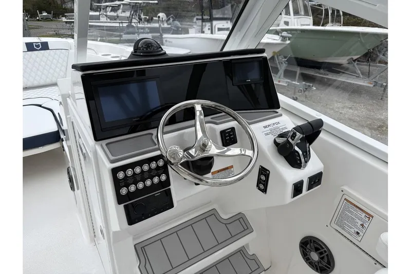 Slide: The Image of 2026 Sea Fox 268 Traveler boat dashboard with steering wheel and control panel. - 12
