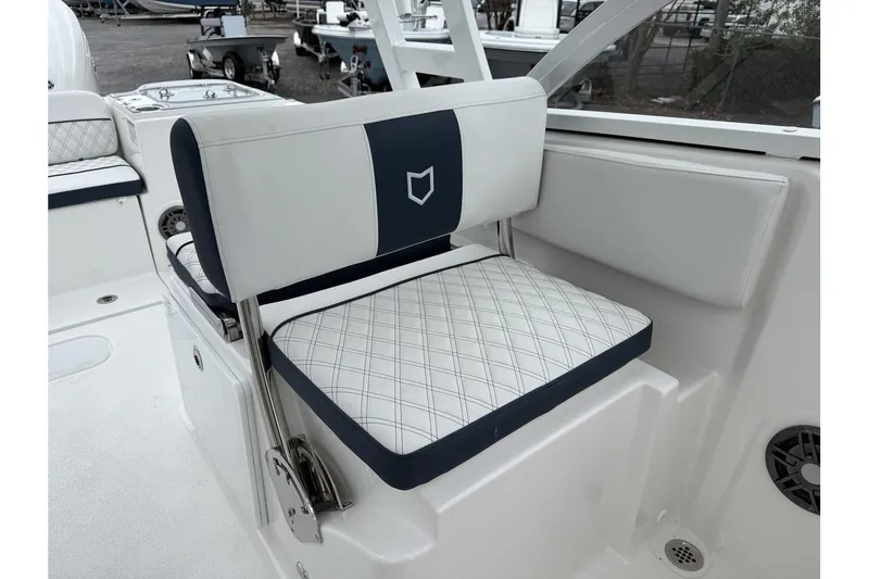 Slide: The Image of 2026 Sea Fox 268 Traveler boat seat with white and navy upholstery, diamond pattern design. - 14
