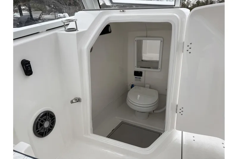 Slide: The Image of 2026 Sea Fox 268 Traveler boat interior with compact marine toilet and mirror. - 18