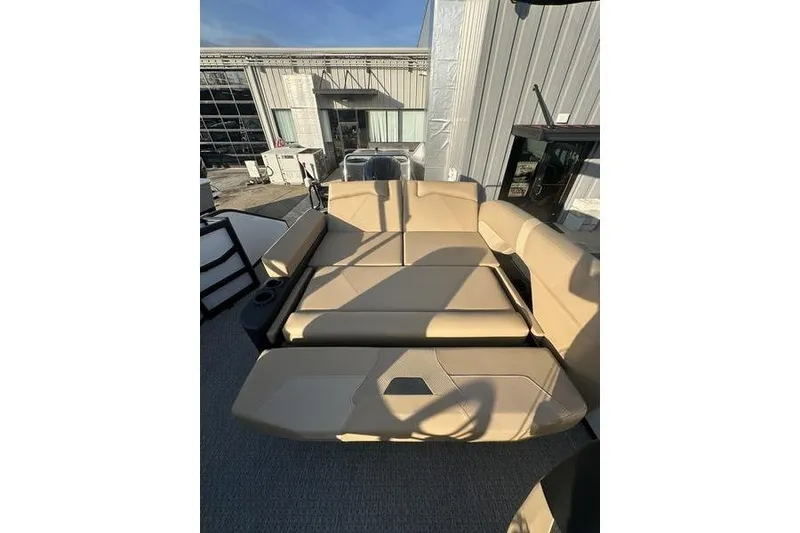 Slide: The Image of 2026 Evotti 523CS boat interior with beige seating and cup holders. - 13