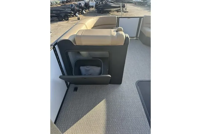 Slide: The Image of Evotti 523CS 2026 boat interior with open storage compartment and beige seating. - 15