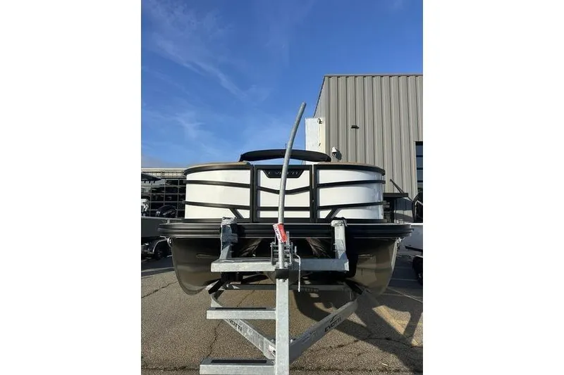 Slide: The Image of 2026 Evotti 523CS boat on trailer, parked outside industrial building. - 3