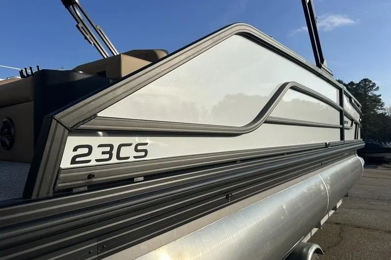 Slide: The Image of 2026 Evotti 523CS pontoon boat side view under clear blue sky. - 6