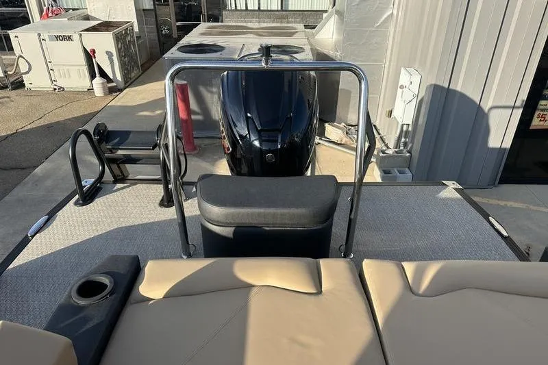 Slide: The Image of 2026 Evotti 523CS boat interior with seating and motor, docked at marina. - 7