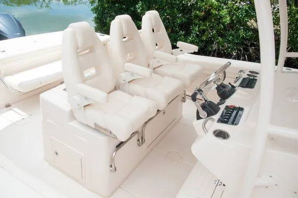 Slide: The Image of Manufacturer Provided Image: 2016 Grady-White Canyon 336 boat cockpit with three white captain's chairs and control panel. - 11