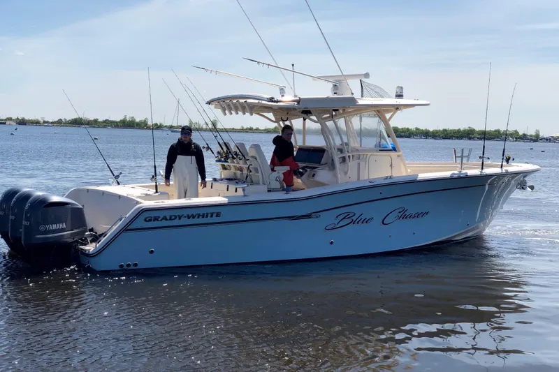 Slide: The Image of 2016 Grady-White Canyon 336 boat named "Blue Chaser" on water with two people aboard. - 18