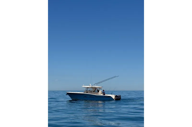 Slide: The Image of 2016 Grady-White Canyon 336 boat on calm ocean under clear blue sky. - 2