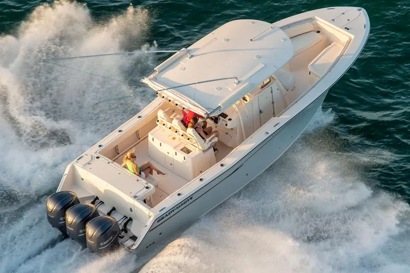 Slide: The Image of Manufacturer Provided Image: 2016 Grady-White Canyon 336 boat cruising on the water with triple outboard engines. - 7