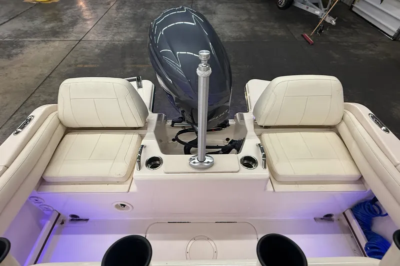 Slide: The Image of 2023 Grady-White Fisherman 216 boat interior with seating and motor, in a garage setting. - 12