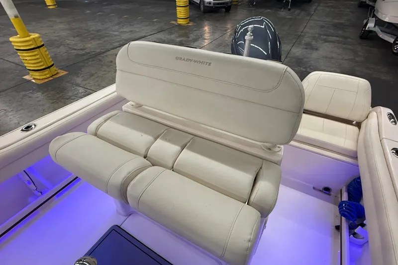 Slide: The Image of 2023 Grady-White Fisherman 216 boat interior with cushioned seating and ambient blue lighting. - 15