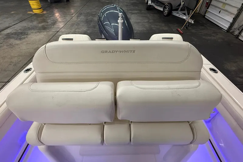Slide: The Image of 2023 Grady-White Fisherman 216 boat seating with illuminated deck in a garage setting. - 16