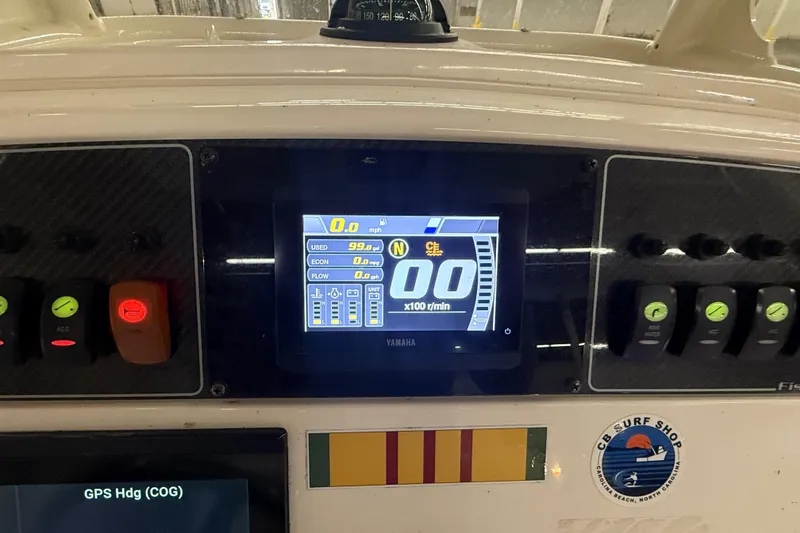Slide: The Image of 2023 Grady-White Fisherman 216 dashboard with Yamaha display and control switches. - 18
