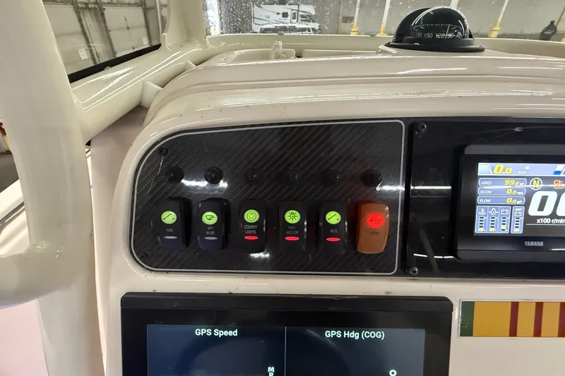 Slide: The Image of Control panel of 2023 Grady-White Fisherman 216 boat with switches and display. - 19