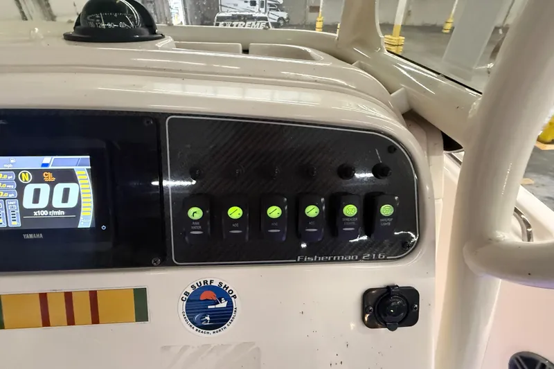 Slide: The Image of 2023 Grady-White Fisherman 216 dashboard with Yamaha display and control switches. - 20