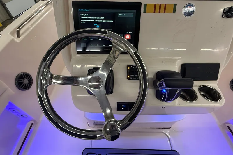 Slide: The Image of 2023 Grady-White Fisherman 216 helm with steering wheel and control panel. - 24