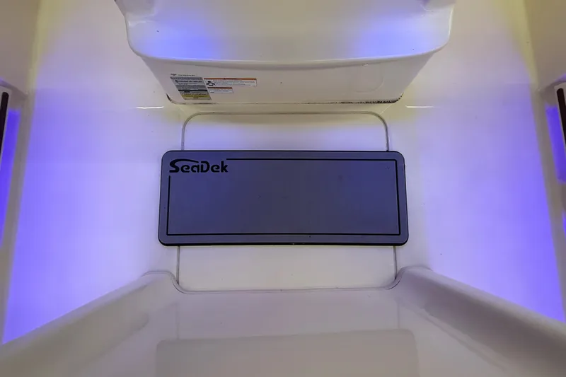 Slide: The Image of 2023 Grady-White Fisherman 216 boat interior with SeaDek flooring and ambient lighting. - 25