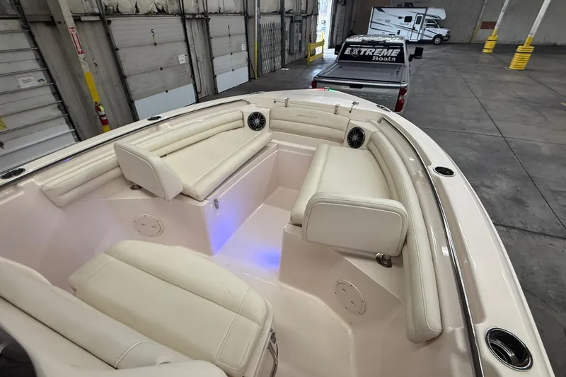 Slide: The Image of 2023 Grady-White Fisherman 216 boat interior with cushioned seating and speakers. - 32