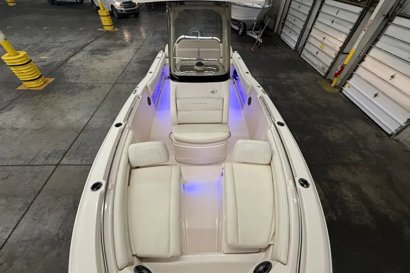 Slide: The Image of 2023 Grady-White Fisherman 216 boat interior with white seating and blue accent lighting. - 38