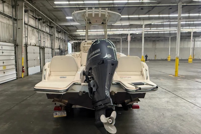 Slide: The Image of 2023 Grady-White Fisherman 216 boat with Yamaha engine in a warehouse setting. - 5