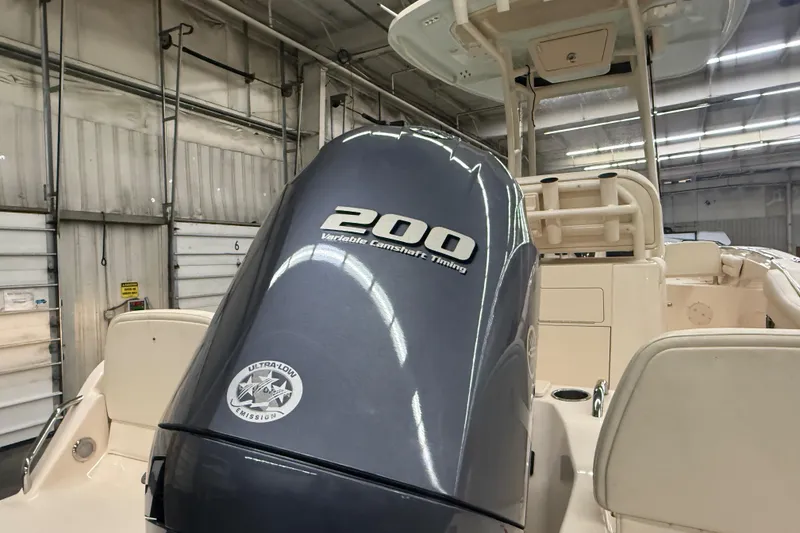 Slide: The Image of 2023 Grady-White Fisherman 216 boat with 200 horsepower engine in a warehouse setting. - 6