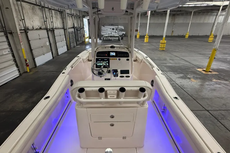 Slide: The Image of 2023 Grady-White Fisherman 216 boat interior with illuminated console in warehouse setting. - 9