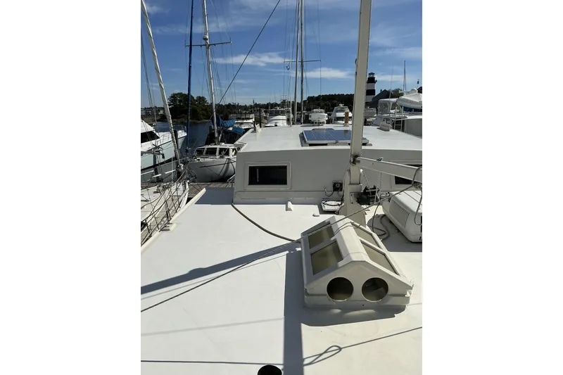 Slide: The Image of 2009 Hugh Huff Custom Pilothouse Trawler docked, showcasing deck and equipment under clear sky. - 10