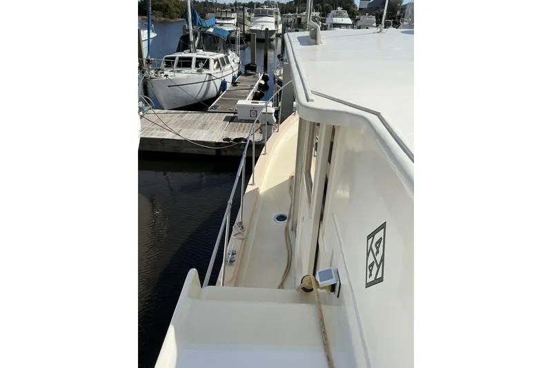 Slide: The Image of 2009 Hugh Huff Custom Pilothouse Trawler docked at marina, side view. - 11