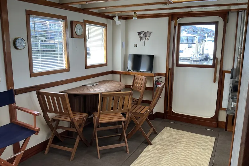 Slide: The Image of Interior of 2009 Hugh Huff Custom Pilothouse Trawler with wooden furniture and nautical decor. - 15