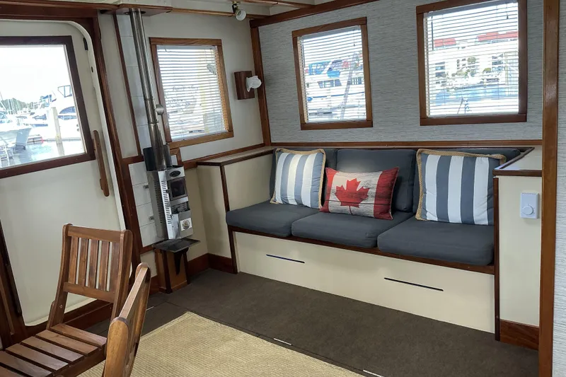Slide: The Image of Cozy interior of 2009 Hugh Huff Custom Pilothouse Trawler with nautical decor and seating. - 17