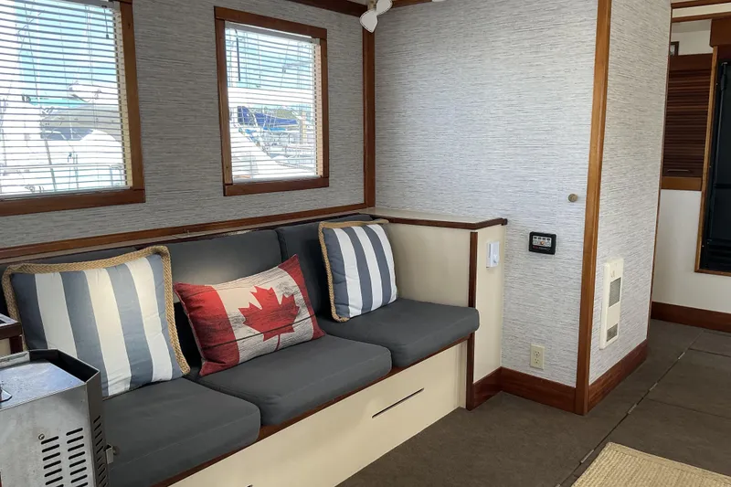 Slide: The Image of Interior of 2009 Hugh Huff Custom Pilothouse Trawler with cozy seating and nautical decor. - 18