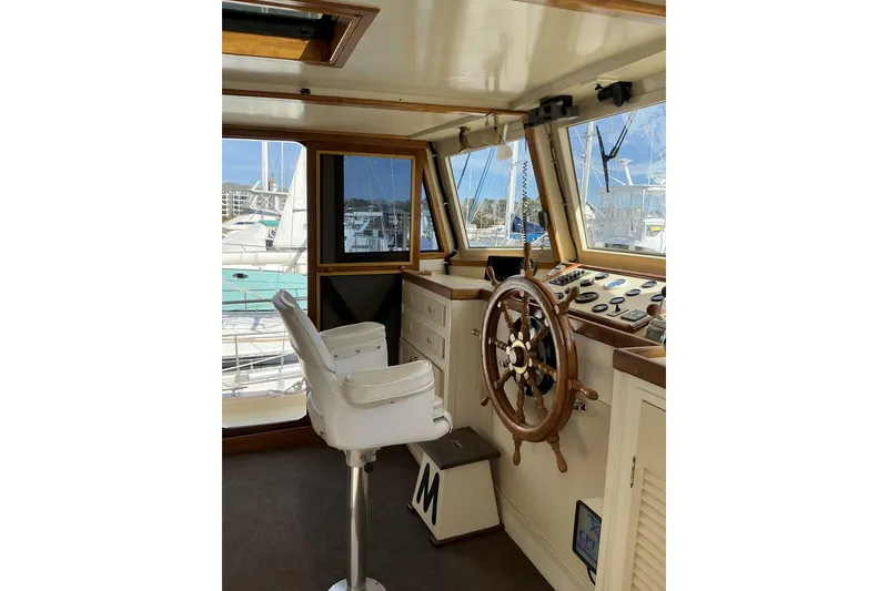 Slide: The Image of Pilothouse interior of 2009 Hugh Huff Custom Pilothouse Trawler with wooden steering wheel. - 27