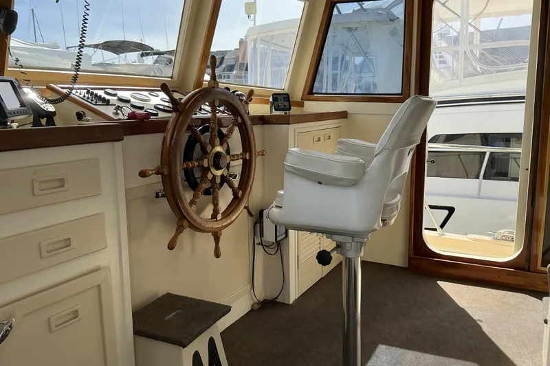 Slide: The Image of Pilothouse interior of 2009 Hugh Huff Custom Trawler with steering wheel and captain's chair. - 28
