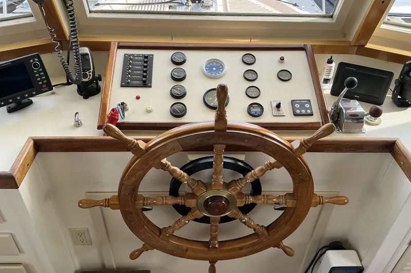 Slide: The Image of Pilothouse of 2009 Hugh Huff Custom Trawler with wooden wheel and navigation instruments. - 29