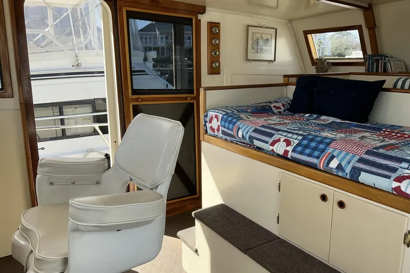 Slide: The Image of Interior of 2009 Hugh Huff Custom Pilothouse Trawler with seating and cozy bed area. - 30