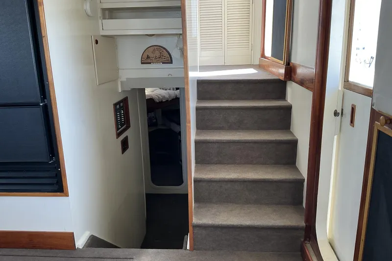 Slide: The Image of Interior stairs of 2009 Hugh Huff Custom Pilothouse Trawler, featuring carpet and wood accents. - 33