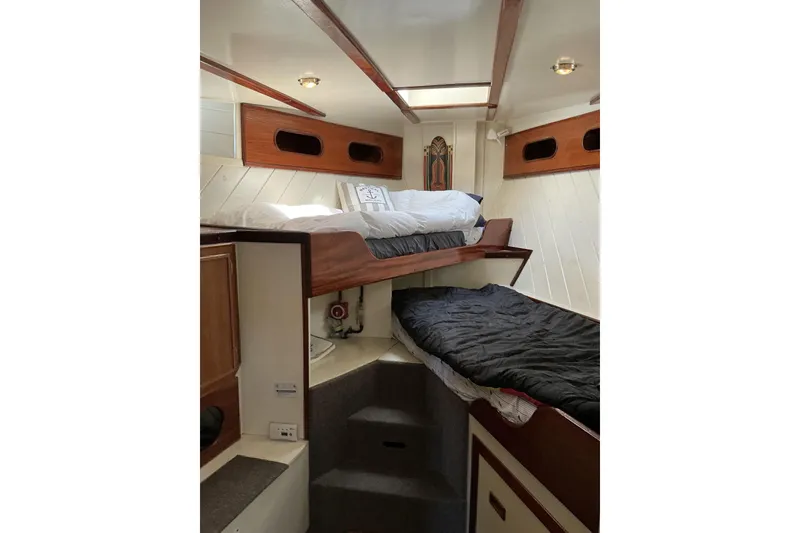 Slide: The Image of Interior of 2009 Hugh Huff Custom Pilothouse Trawler with cozy bunk beds and wooden accents. - 36