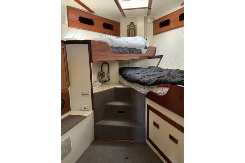 Slide: The Image of Interior of 2009 Hugh Huff Custom Pilothouse Trawler with bunk beds and wooden accents. - 37