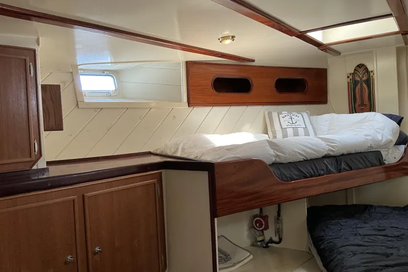 Slide: The Image of Cozy cabin interior of 2009 Hugh Huff Custom Pilothouse Trawler with wooden accents and bedding. - 38