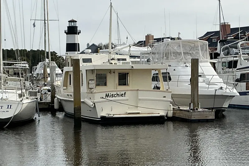 Slide: The Image of 2009 Hugh Huff Custom Pilothouse Trawler "Mischief" docked in a marina. - 4