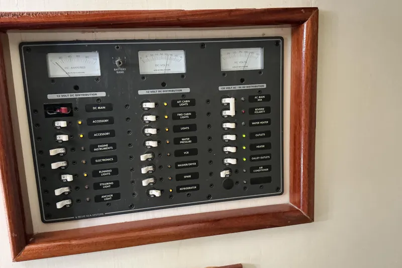 Slide: The Image of Electrical panel on 2009 Hugh Huff Custom Pilothouse Trawler, featuring various switches and gauges. - 40
