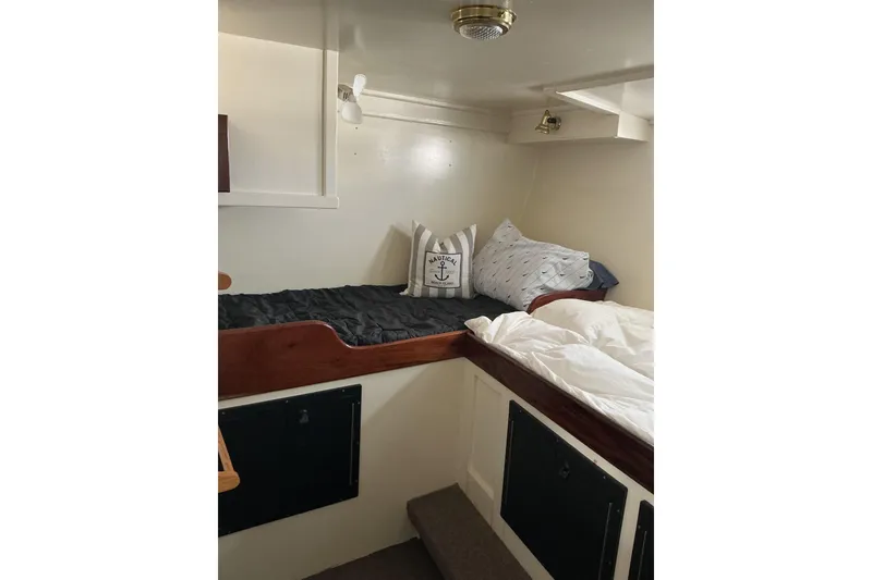 Slide: The Image of Cozy cabin interior of 2009 Hugh Huff Custom Pilothouse Trawler with nautical-themed pillows. - 42